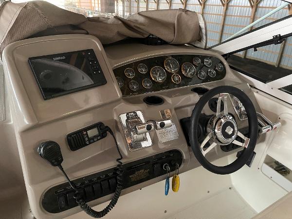 Slide: The Image of 2001 Cruisers Yachts 3470 Express helm with steering wheel, gauges, and navigation equipment. - 1