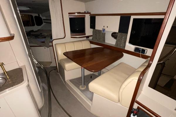 Slide: The Image of 2001 Cruisers Yachts 3470 Express interior with dining area and seating. - 5