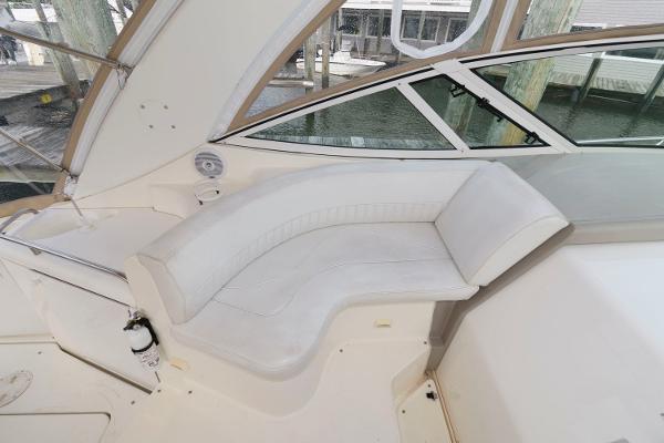 Slide: The Image of 2002 Cruisers Yachts 3470 Express interior seating area with white upholstery. - 11