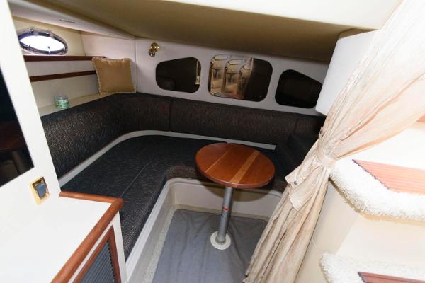 Slide: The Image of 2002 Cruisers Yachts 3470 Express cabin interior with seating and table. - 17