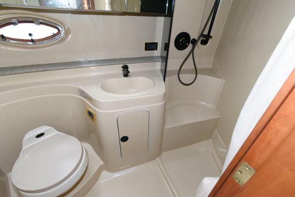 Slide: The Image of 2002 Cruisers Yachts 3470 Express bathroom with sink, toilet, and shower. - 18