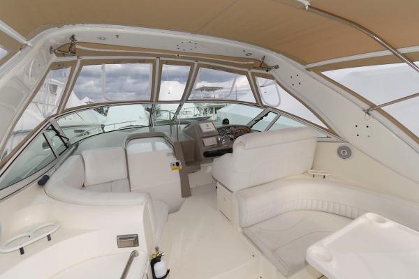 Slide: The Image of Interior of 2002 Cruisers Yachts 3470 Express with white seating and helm station. - 2
