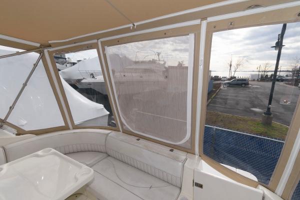 Slide: The Image of Interior view of 2002 Cruisers Yachts 3470 Express with enclosed seating area. - 3