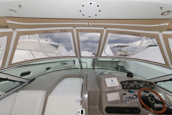 Slide: The Image of 2002 Cruisers Yachts 3470 Express helm with dashboard and steering wheel. - 5