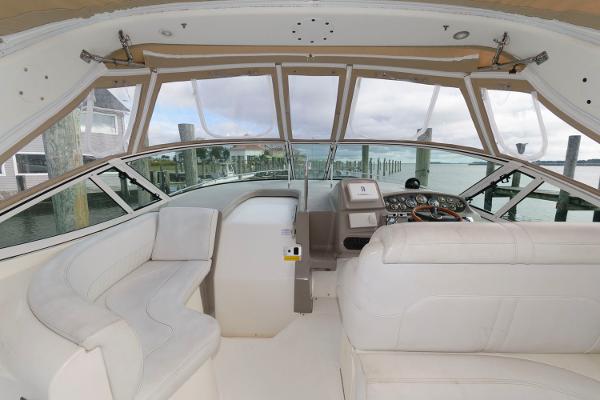 Slide: The Image of 2002 Cruisers Yachts 3470 Express cockpit with white seating and helm station. - 8