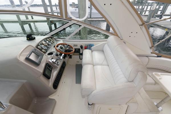 Slide: The Image of 2002 Cruisers Yachts 3470 Express helm with leather seating and control panel. - 9