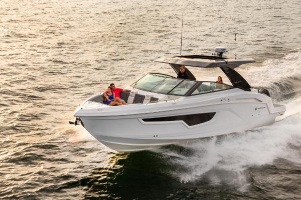 Slide: The Image of 2023 Cruisers Yachts 34 GLS speeding on water with passengers onboard. - 1