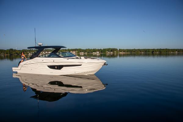 Slide: The Image of 2023 Cruisers Yachts 34 GLS on calm water with clear blue sky. - 10
