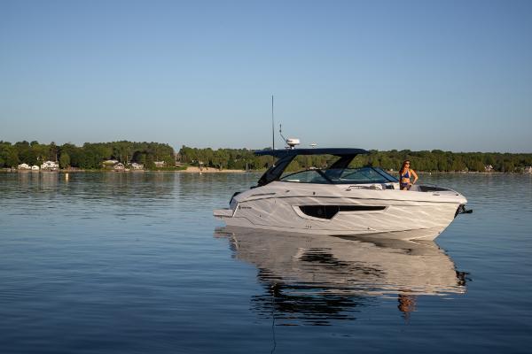 Slide: The Image of 2023 Cruisers Yachts 34 GLS on calm lake with scenic background. - 12