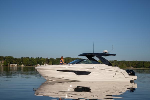Slide: The Image of 2023 Cruisers Yachts 34 GLS on calm water with scenic background. - 13