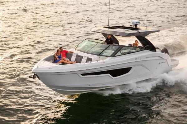 Slide: The Image of 2023 Cruisers Yachts 34 GLS cruising on water with passengers onboard. - 2