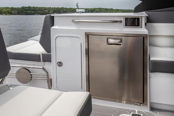 Slide: The Image of 2023 Cruisers Yachts 34 GLS interior, featuring a sleek kitchenette with stainless steel appliances. - 23