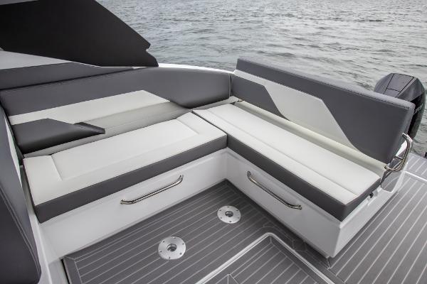 Slide: The Image of 2023 Cruisers Yachts 34 GLS seating area with modern design on the water. - 26