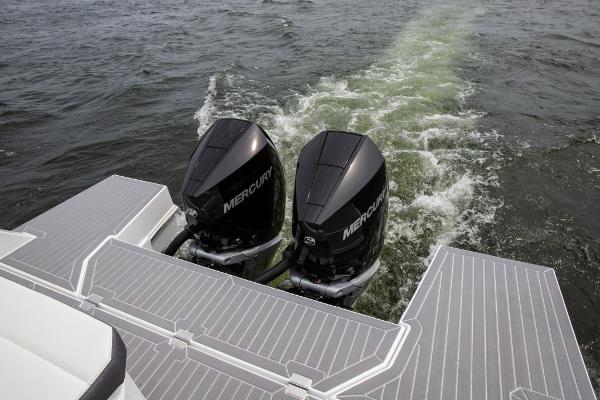 Slide: The Image of 2023 Cruisers Yachts 34 GLS with twin Mercury outboard engines on water. - 29