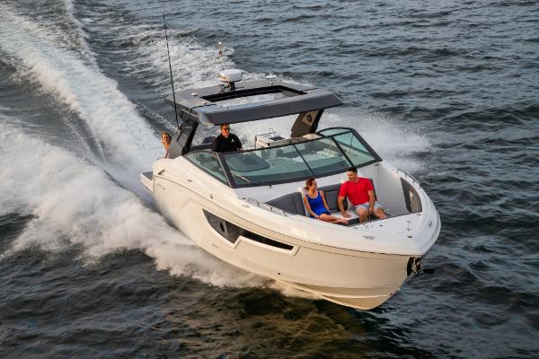 Slide: The Image of 2023 Cruisers Yachts 34 GLS speeding on water with passengers. - 3