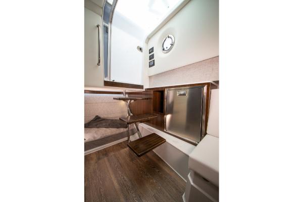 Slide: The Image of 2023 Cruisers Yachts 34 GLS interior cabin with wooden flooring and modern amenities. - 35