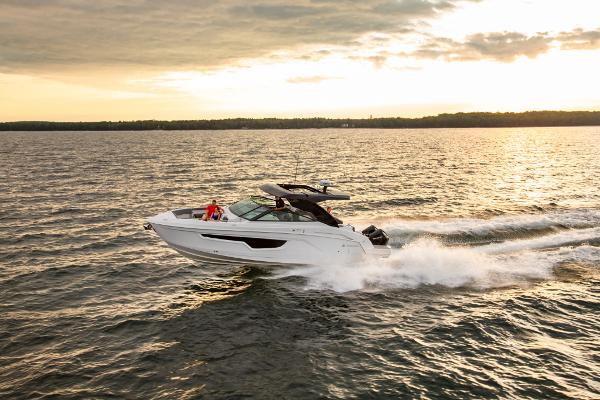 Slide: The Image of 2023 Cruisers Yachts 34 GLS speeding on open water at sunset. - 4