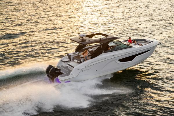 Slide: The Image of 2023 Cruisers Yachts 34 GLS speeding on water at sunset. - 5
