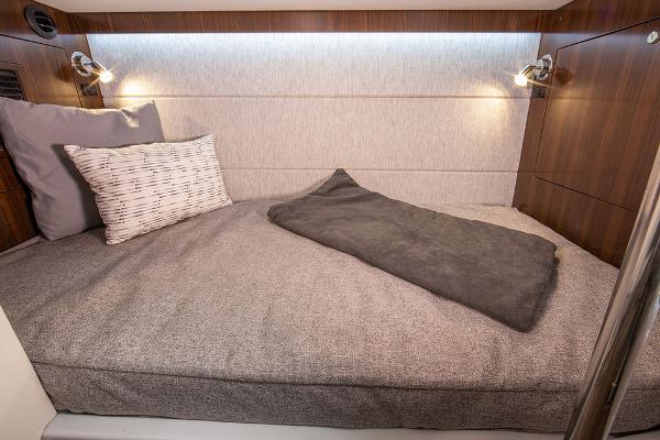 Slide: The Image of 2023 Cruisers Yachts 34 GLS cabin interior with cozy bed and modern lighting. - 54