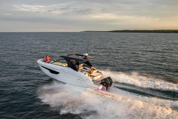 Slide: The Image of 2023 Cruisers Yachts 34 GLS speeding on open water at sunset. - 6