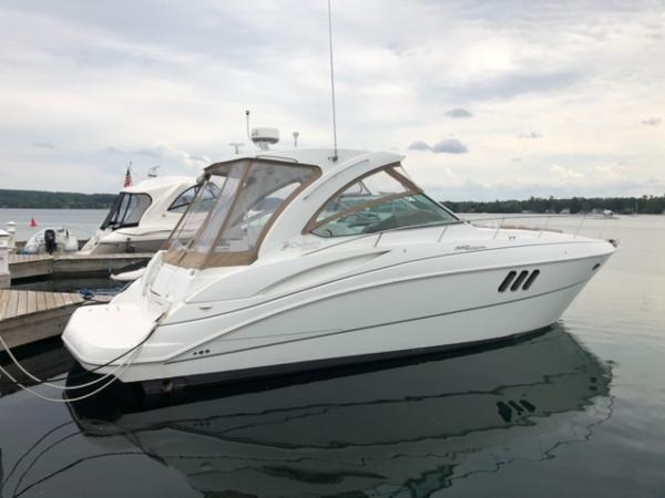 The Image of 2008 Cruisers Yachts 360 Express docked on calm water under cloudy skies. - 0