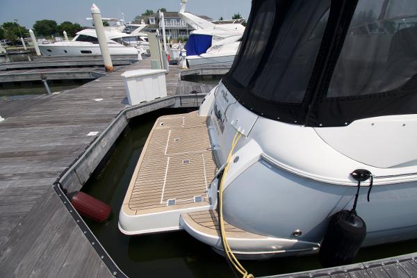 Slide: The Image of 2005 Cruisers Yachts 370 Express docked at marina with wooden deck. - 3