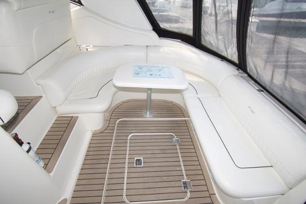 Slide: The Image of 2005 Cruisers Yachts 370 Express interior with white seating and wooden flooring. - 9
