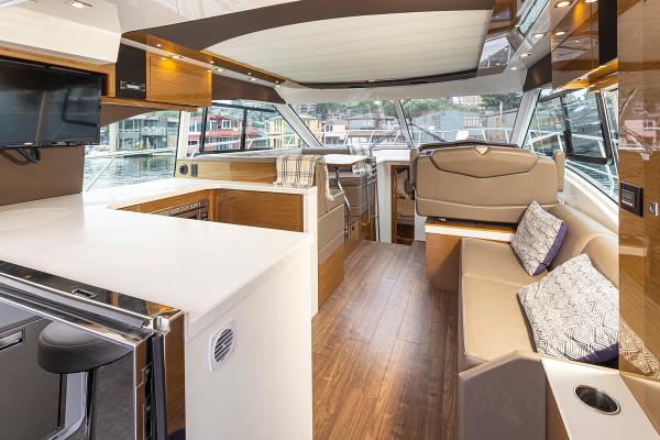 Slide: The Image of Luxurious interior of 2018 Cruisers Yachts 45 Cantius with modern furnishings and panoramic windows. - 10