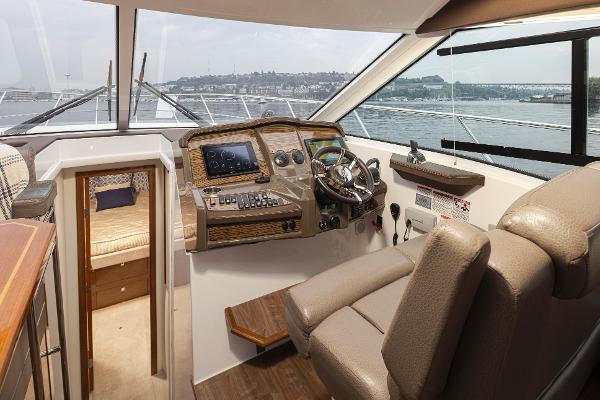 Slide: The Image of 2018 Cruisers Yachts 45 Cantius helm station with luxurious interior and panoramic views. - 12