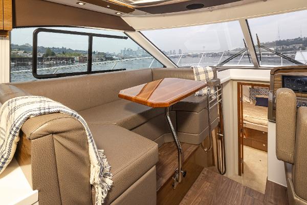 Slide: The Image of 2018 Cruisers Yachts 45 Cantius interior with dining area and panoramic windows. - 14