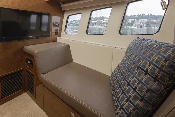 Slide: The Image of Interior lounge area of 2018 Cruisers Yachts 45 Cantius with TV and waterfront view. - 22