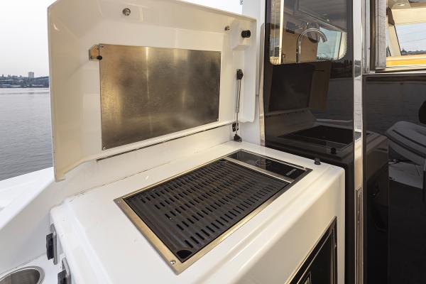 Slide: The Image of Outdoor grill on 2018 Cruisers Yachts 45 Cantius, docked by the water. - 28