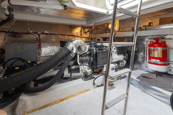 Slide: The Image of Engine room of a 2018 Cruisers Yachts 45 Cantius with visible machinery and ladder. - 38