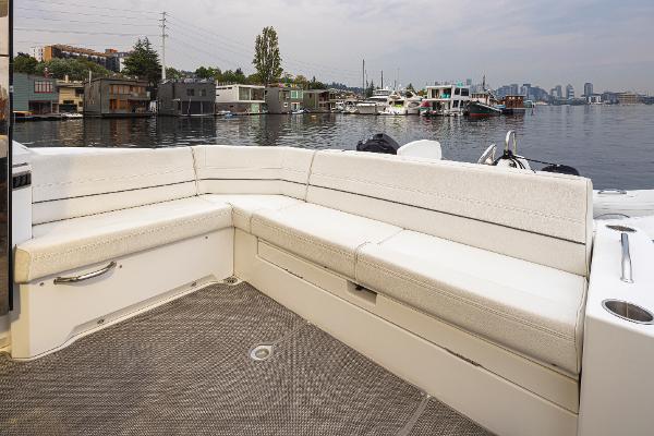 Slide: The Image of 2018 Cruisers Yachts 45 Cantius boat with white seating and waterfront view. - 7