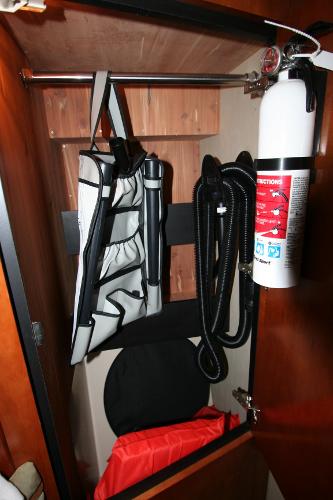 Slide: The Image of Storage compartment in 2008 Cruisers Yachts 460 Express with safety equipment and fire extinguisher. - 33