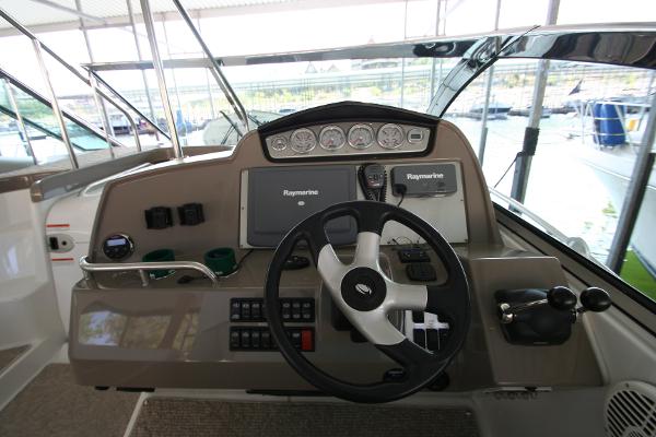 Slide: The Image of 2008 Cruisers Yachts 460 Express helm with Raymarine navigation system and steering wheel. - 42