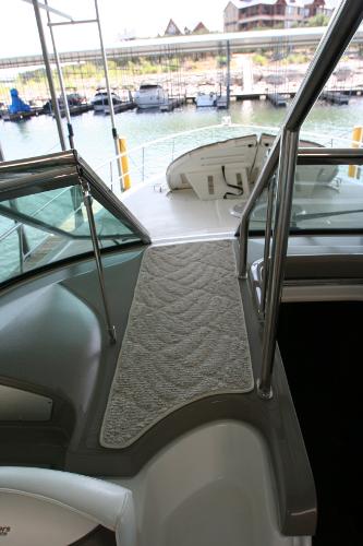 Slide: The Image of 2008 Cruisers Yachts 460 Express deck with marina view, featuring sleek design and modern amenities. - 47