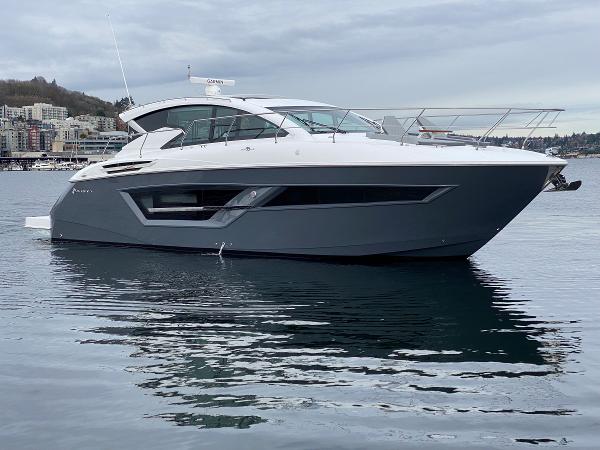 The Image of 2023 Cruisers Yachts 46 Cantius luxury boat on calm water, side view. - 0