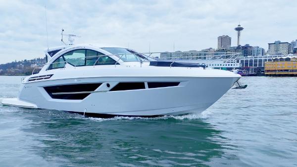 The Image of 2024 Cruisers Yachts 50 Cantius on water with city skyline background. - 0