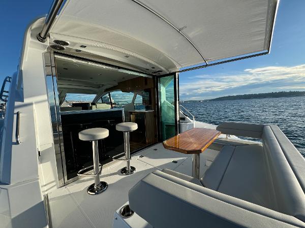 Slide: The Image of 2024 Cruisers Yachts 50 Cantius luxury yacht with open deck and ocean view. - 10