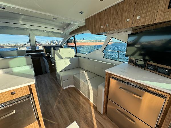 Slide: The Image of Interior of 2024 Cruisers Yachts 50 Cantius with modern furnishings and waterfront view. - 12