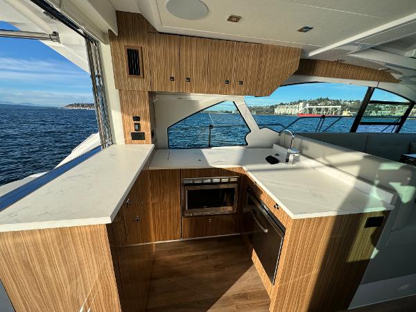 Slide: The Image of Modern kitchen on 2024 Cruisers Yachts 50 Cantius with ocean view. - 14