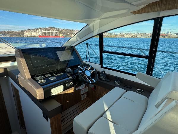 Slide: The Image of 2024 Cruisers Yachts 50 Cantius helm station with waterfront view. - 17
