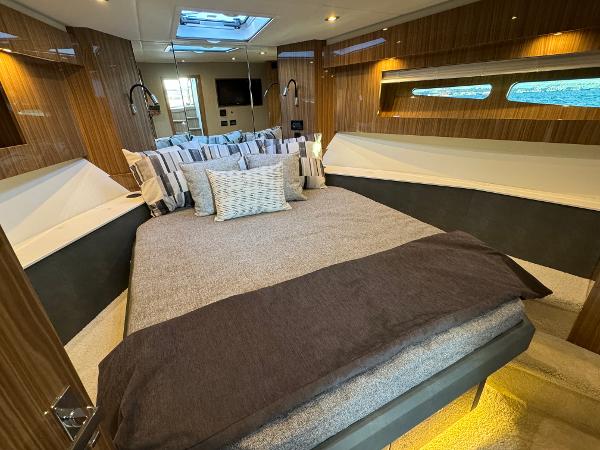 Slide: The Image of Luxurious bedroom interior of 2024 Cruisers Yachts 50 Cantius with modern design and ample lighting. - 18