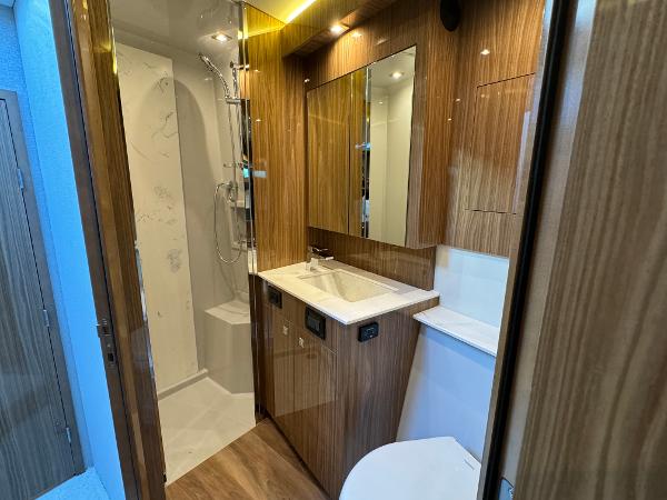 Slide: The Image of Luxurious bathroom in 2024 Cruisers Yachts 50 Cantius with modern fixtures and wood accents. - 19