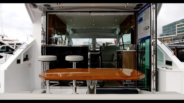 Slide: The Image of 2024 Cruisers Yachts 50 Cantius interior with bar stools and wooden table. - 25