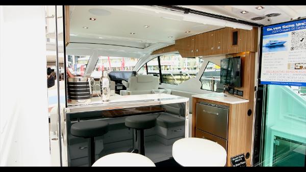 Slide: The Image of 2024 Cruisers Yachts 50 Cantius interior with modern kitchen and seating area. - 26