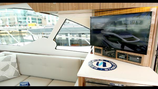 Slide: The Image of Interior of 2024 Cruisers Yachts 50 Cantius with TV and seating area. - 31
