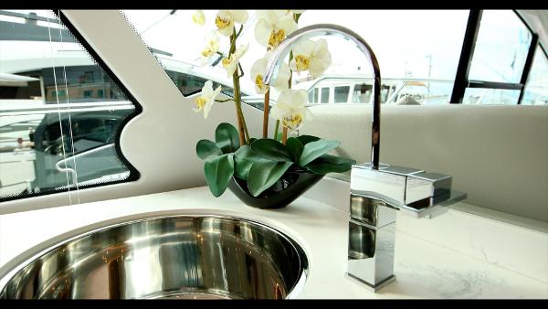 Slide: The Image of Modern kitchen sink and faucet on the 2024 Cruisers Yachts 50 Cantius. - 32