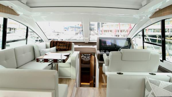 Slide: The Image of Interior of 2024 Cruisers Yachts 50 Cantius, featuring luxurious seating and modern helm. - 34